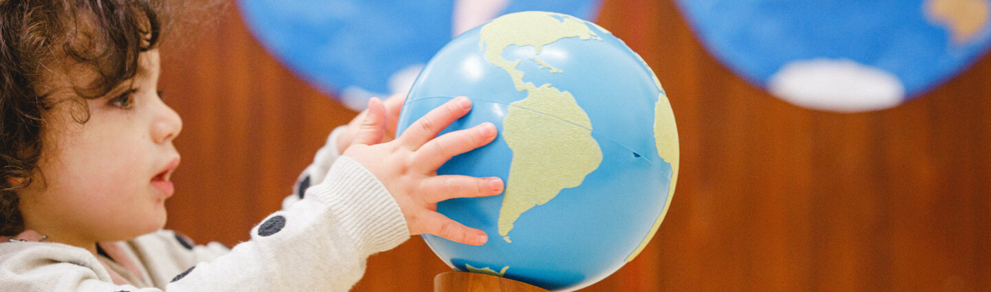 Child holding globe