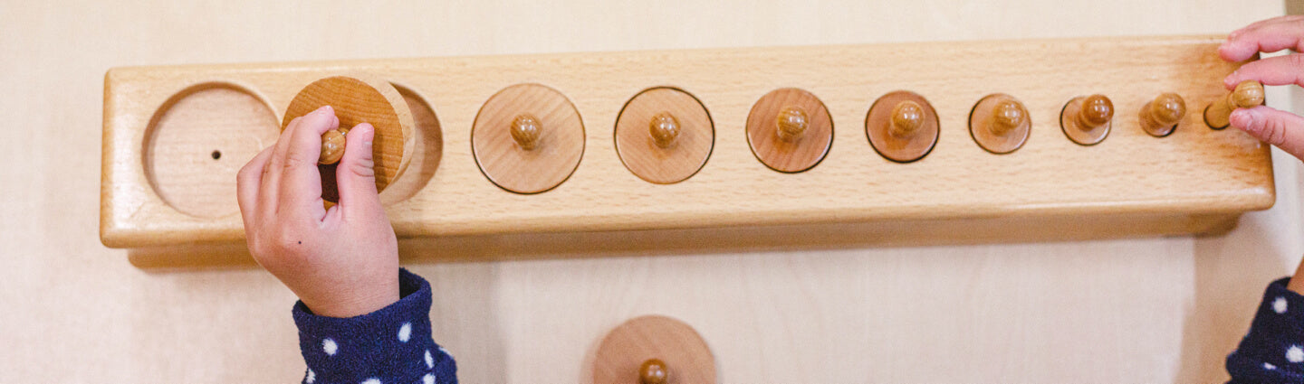 Child placing round circles in holes
