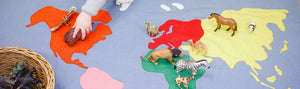 Child playing with map and animals